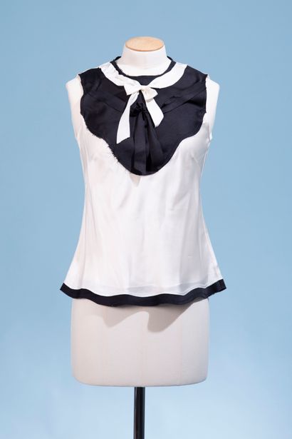 null CHANEL. 
Black and white silk top, round collar decorated with two bows, sleeveless,...