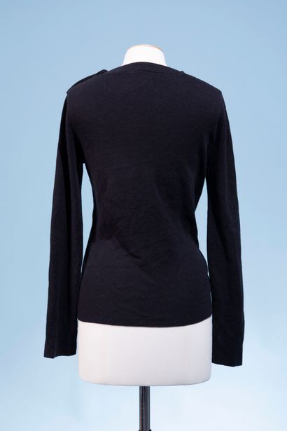null CHANEL Uniform.
Black wool sweater, closed on the shoulder by three semi-hemispheric...