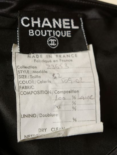 null CHANEL.

Black wool cocktail dress highlighted with black silk braids, straight,...
