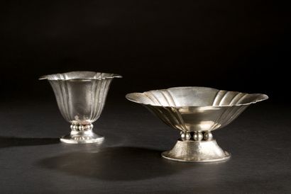 Two oval cups, one tall, one taller and narrower,...