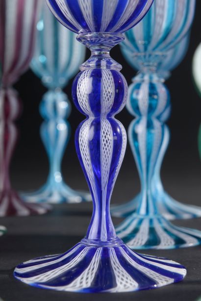 null MURANO.
Sixteen stemmed glasses in colored glass with filigree decoration "a...