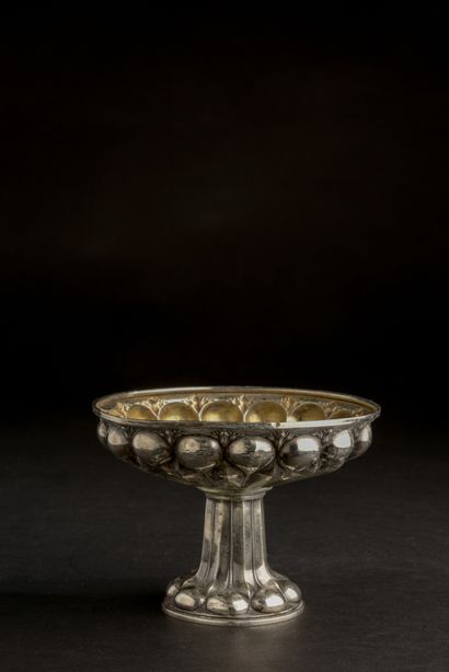 null Carl BECKER (XXe siècle).
Coupe sur pied en argent 800 millièmes repoussé de...