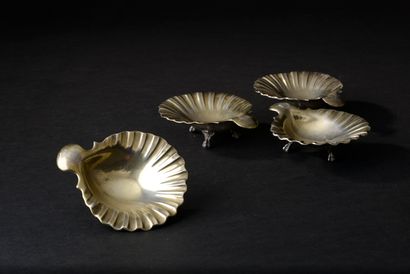 Suite of four small shell cups resting on...