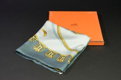 null HERMÈS "The golden horsemen".
Silk square in shades of gold and blue, signed...