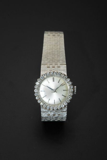 null 18k white gold wristwatch, the round case with bezel set with round brilliant...