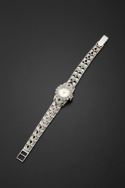 null ECLAIR.
Lady's wristwatch in 18k white gold, the round case drawn with a flower...