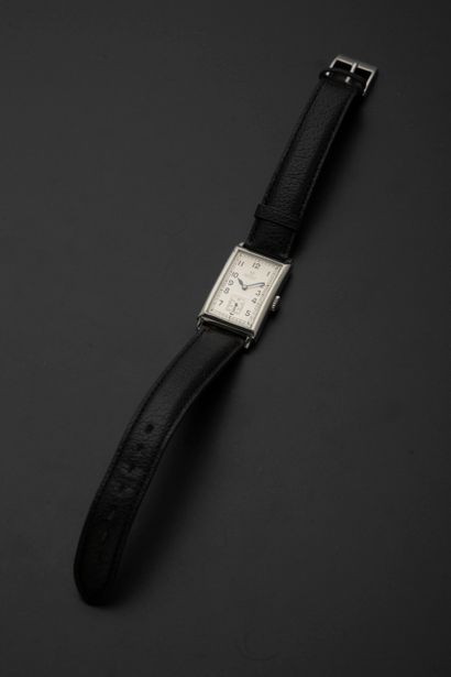 null OMEGA.
Steel wristwatch, the domed rectangular case, the silver dial with Arabic...