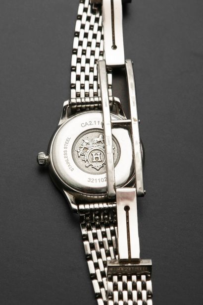 null HERMÈS "Slim".
Ladies' watch in steel, round case, silver dial with Arabic numerals...