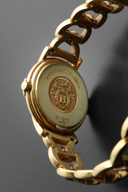 null HERMÈS "Ruban".
Ladies' wristwatch in 18k yellow gold, round case, white dial...
