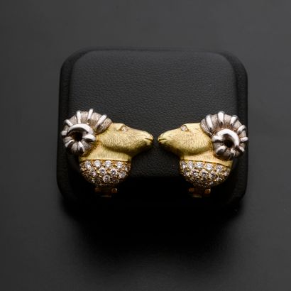 null Pair of two-tone 18k gold ear clips, each featuring a ram's head, its eyes and...