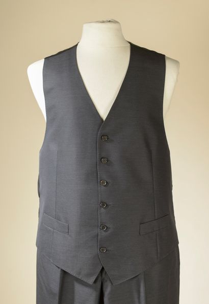 null CHRISTIAN DIOR. 
Three-piece suit in gray wool and silk. The fitted jacket,...