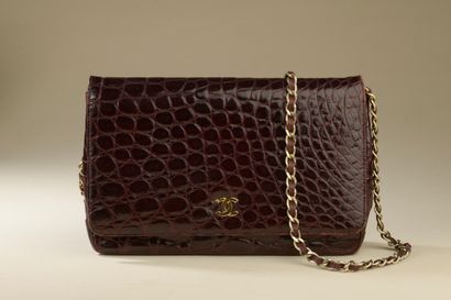 CHANEL. 
Classic bag in plum crocodile with...