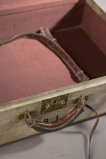 null HERMÈS.
Rectangular rigid suitcase sheathed in parchment monogrammed G.L., one...