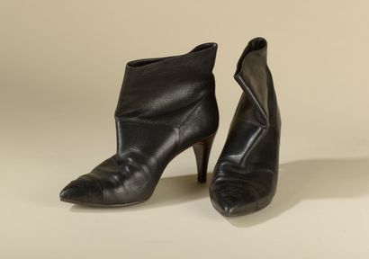 null CHANEL. 
Pair of black grained leather ankle boots, double C stitched toe and...