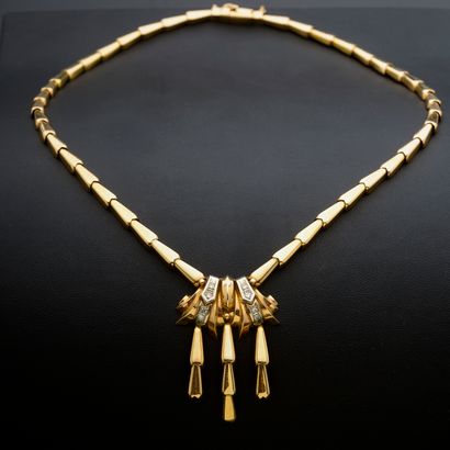 null 18k yellow gold necklace with a central motif of scrolls and pendants highlighted...