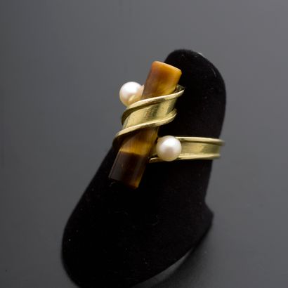 null Ring in 18k yellow gold, the bezel wrapped around a tiger eye quartz stick and...