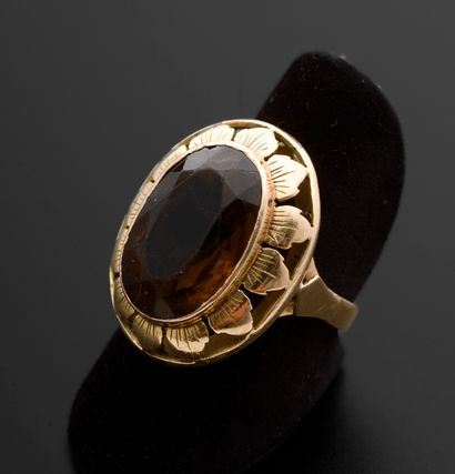 null 18k rose gold ring set with an oval citrine, the bezel openwork and engraved...