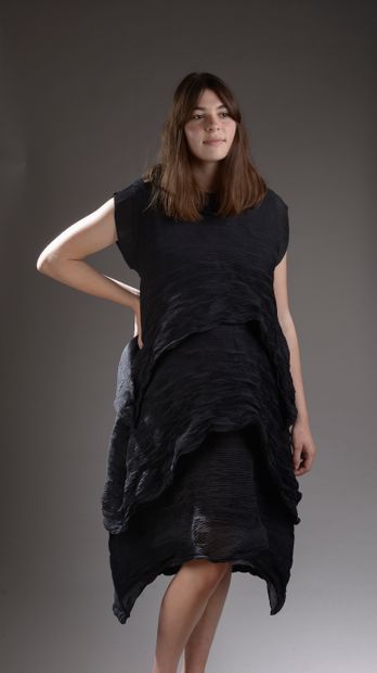 ISSEY MIYAKE.
Dress in black pleated polyester...