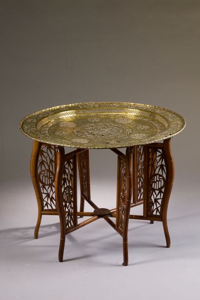Circular coffee table with openwork copper...