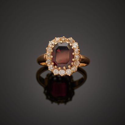 null 18k yellow gold Pompadour ring set with an oval almandine garnet in a setting...