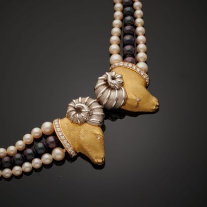 null Necklace composed of three rows of cultured pearls, two white and one black,...