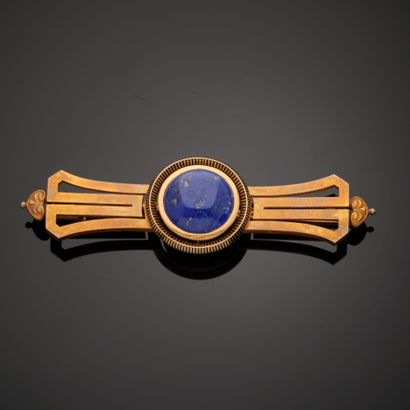 null 18k yellow gold brooch with a lapis lazuli cabochon in a black enamel setting,...