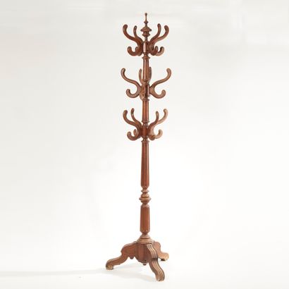 null Moulded oak "parrot" coat stand with 24 hangers, the fluted shaft resting on...