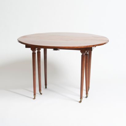 null Round mahogany dining table with shutters, the middle section able to accommodate...