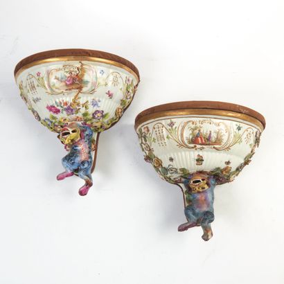 null Pair of polychrome porcelain half-moon sconces decorated with flowers supported...
