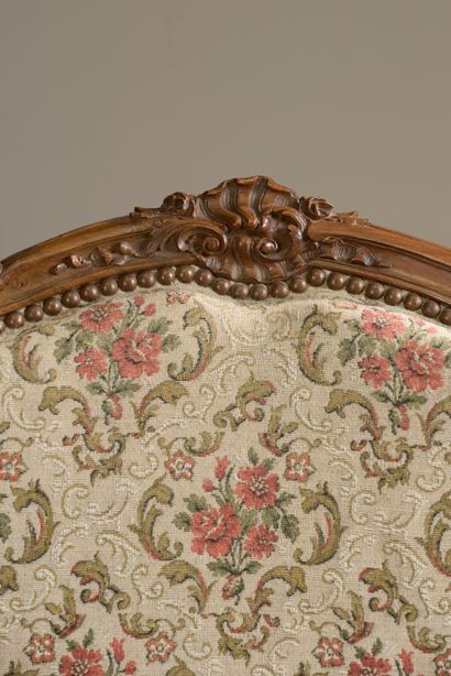 null Armchair with cabriolet back in beech, molded and carved with shells, acanthus...