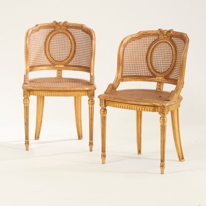 null Pair of caned chairs in molded, carved, stuccoed and gilded wood (chips), the...