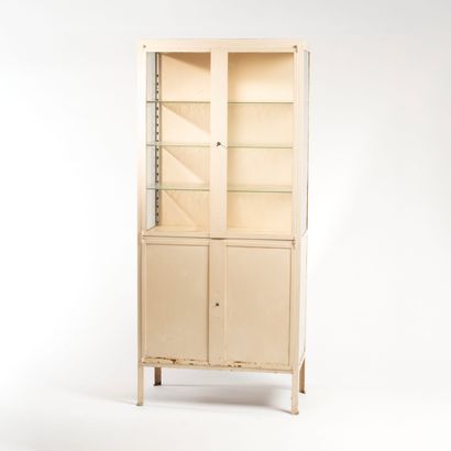 null Medical cabinet in beige lacquered metal, opening with two glass doors at the...