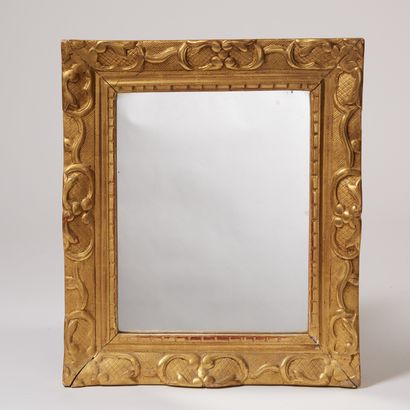 null Small rectangular mirror in carved, stuccoed and gilded wood, the uprights decorated...