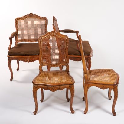 null Pair of caned armchairs in molded wood, richly carved with staples, bat-wing...