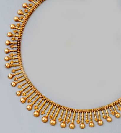 null COLLIER draperie en or jaune à tiges baguées terminées par des demies boules...