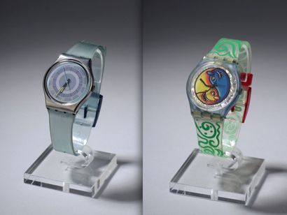 null SWATCH SWISS. Deux montres, l'une bleu gris, le bracelet translucide et le cadran...