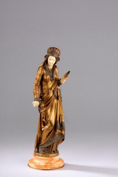null Statuette chryséléphantine en ivoire et bronze patiné et doré figurant une fileuse....