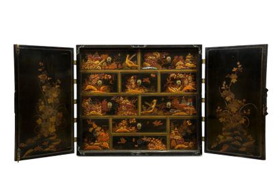 Wooden cabinet lacquered in gold on a black...