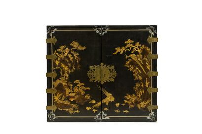 null Wooden cabinet lacquered in gold on a black background with relief decoration...