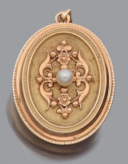 A yellow gold (750%) oval hinged pendant,...