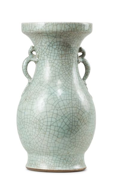 CHINE - XIXe siècle 
A celadon enamelled porcelain baluster vase with two handles,...