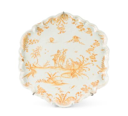 LYON Circular tray with contoured edge in earthenware decorated in orange monochrome...