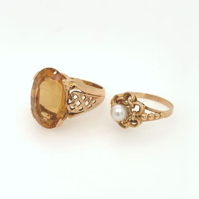 null Two yellow gold (750‰) openwork rings: one with a cultured pearl, and the other...