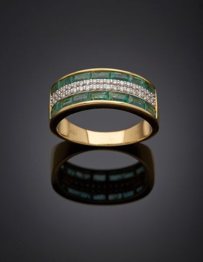 null Yellow and white gold (750‰) "bandeau" ring set with calibrated emeralds and...