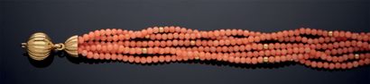 null BRACELET composed of six rows of coral beads alternated with sixteen gold beads....