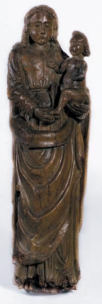 null Importante Vierge à l'Enfant en bois sculpté portant des traces de polychromie....