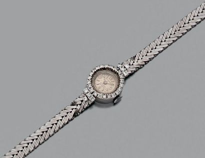 null Bracelet-montre ronde de dame en or gris (750 millièmes). Lunette et attaches...