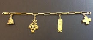 null Bracelet en or jaune (750 millièmes) à maillons oblongs, retenant quatre breloques...