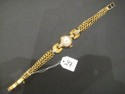 Bracelet-montre ronde de dame en or jaune...