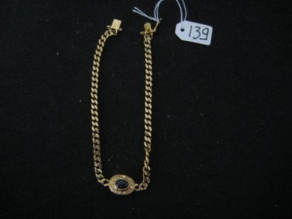 null Bracelet en or jaune 18K (750) à maille gourmette coupée d'un saphir ovale cabochon...